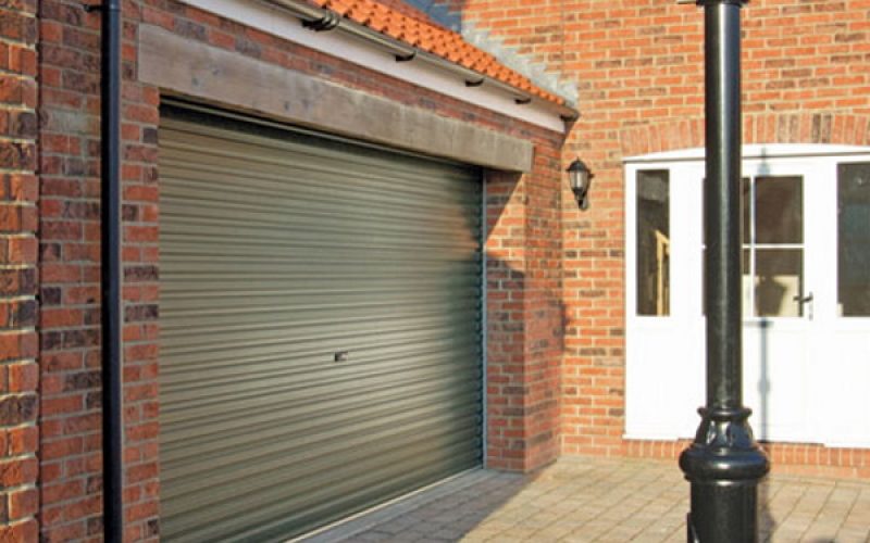 olive green gareg door on the side of a home