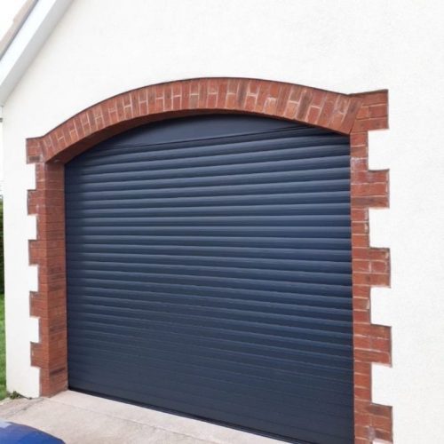 navy blue roller garage door with stylish brick work surrounding