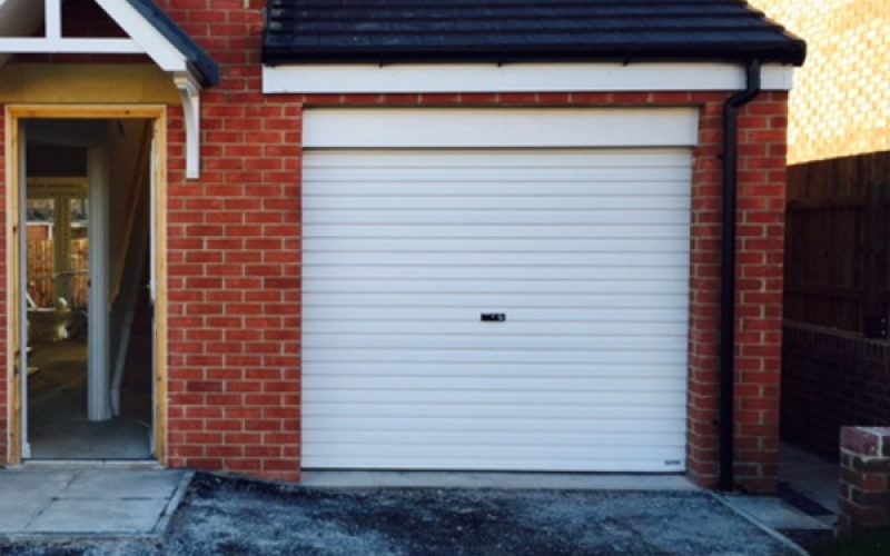 brand new white garage door on large home